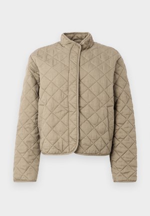 Veste matelassée beige avec un col montant, des manches longues, une fermeture frontale dissimulée et un motif de surpiqûres en forme de losange.