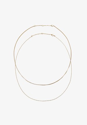 Zwei filigrane goldene Ketten mit kleinen Verschlüssen, angeordnet in überlappenden Kreisen auf weißem Hintergrund.