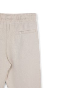 Helle beige Leinenhose mit elastischem Bund. Verfügt über eine einzelne Gesäßtasche, eine glatte Textur und ein gerades Bein-Design.