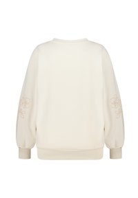 Zacht crèmekleurig sweatshirt met ballonmouwen. Voorzien van geborduurde bloemmotieven in lichtbeige op de mouwen. Geribbelde boorden aan de manchetten en de kraag.