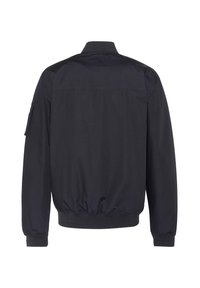 Veste noire à manches longues avec col montant, taille élastique et une poche sur la partie supérieure de la manche gauche, vue de dos.