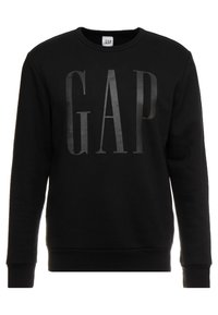 Sudadera de algodón negra con un gran logotipo en relieve en negro "GAP" en el frente. Cuello redondo y mangas largas con puños y dobladillo de canalé.