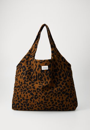 Leopard print tote bag in brown and black fabric with a curved top and long handles; features a Roxy label on the front.