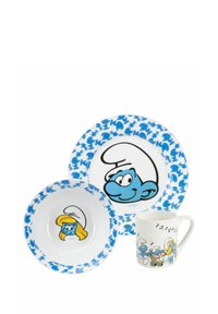 Set di piatti dei Puffi in tre pezzi: piatto grande con accenti blu e faccia di Puffo, ciotola con bordo blu e Puffetta, tazza bianca con motivo dei Puffi.
