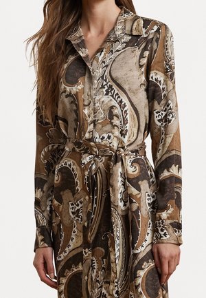 Long-sleeve belted dress with brown, beige, and black paisley pattern, buttoned front, worn by a person with long brown hair.
