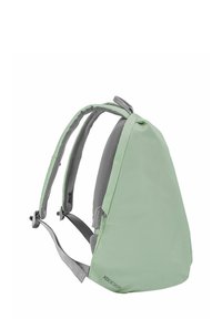 Green backpack with a triangular shape, made of textured fabric, featuring grey padded straps and adjustable buckles for comfort.