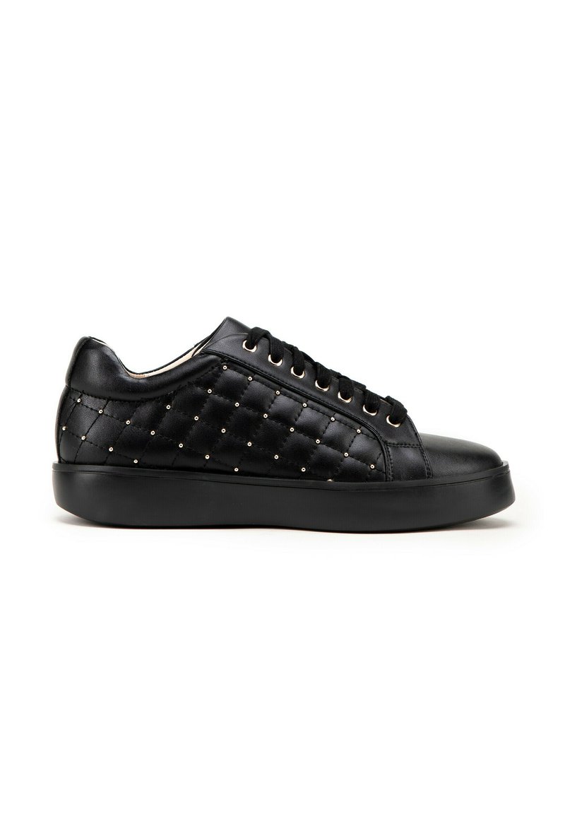 Black quilted sneakers with gold accents, featuring smooth leather and a textured body, rounded toe, and flat rubber sole.