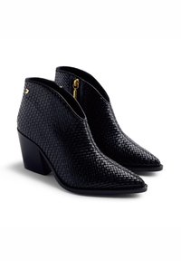 Black woven ankle boots with a pointed toe and block heel. Features a side zipper and gold accent hardware. Textured leather surface.