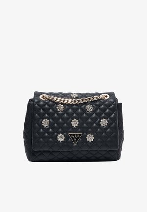 Sac à main matelassé noir Guess avec bandoulière en chaîne dorée et ornements de fleurs en cristal sur le rabat avant.