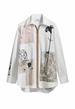 White cotton shirt featuring a front zipper, oversized fit, and collage of black and pastel prints, including flowers and abstract patterns.
