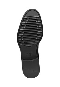 Semelle de chaussure en caoutchouc noir avec une surface texturée comportant des rainures horizontales et verticales. Le logo "GEOX" est en relief.