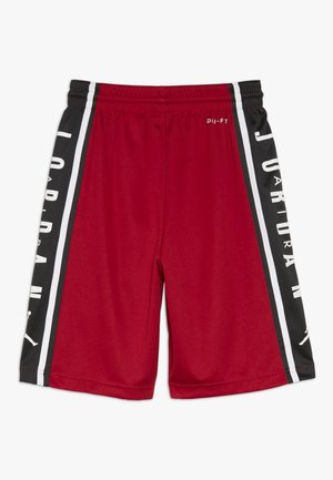 Shorts de sport rouges avec des panneaux latéraux noirs, texte vertical blanc "JORDAN" et une ceinture élastique. Petit logo blanc "Dri-FIT" près du haut.