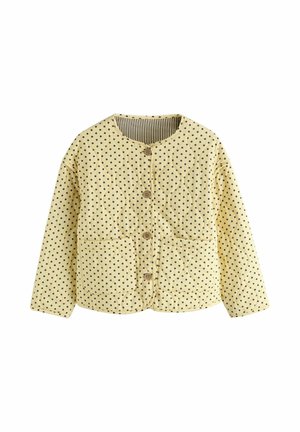 Gul quiltet jakke med sorte polkaprikker, rund hals, knaplukning foran, to forlommer og lange ærmer.