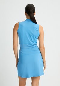 Vestido sin mangas azul con un top ajustado y una falda acampanada. Hecho de una tela ligera y texturizada. Presenta un cuello y una cinturilla ajustable.
