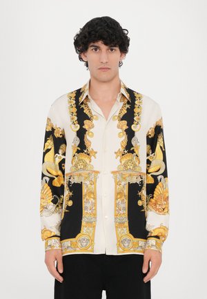 Camicia con un design nero e crema caratterizzato da motivi nautici dorati, grafiche intricate, maniche lunghe e colletto classico.