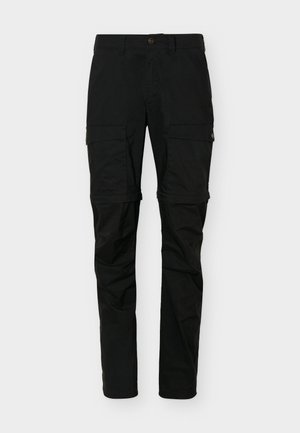 Schwarze Cargo-Hose in Convertible-Optik mit Pattentaschen auf den Oberschenkeln und Reißverschlüssen am Knöchel zur Längenanpassung.