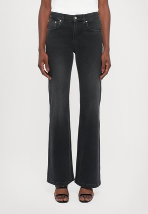 Flared black denim jeans with a fitted waist, front and back pockets, silver hardware, and a smooth texture.