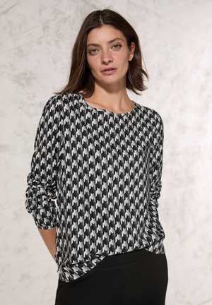 Černobílý vzorovaný top s houndstooth, dlouhý rukáv, s kulatým výstřihem a řasenými rukávy, vyrobený z měkké, lehké látky.