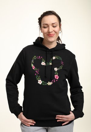 Black hoodie featuring a floral heart design in pink, white, and green, with a drawstring and a relaxed fit.