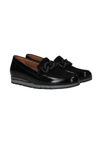 Black patent leather loafers with a low wedge heel, featuring a decorative chain detail and a textured sole for traction.