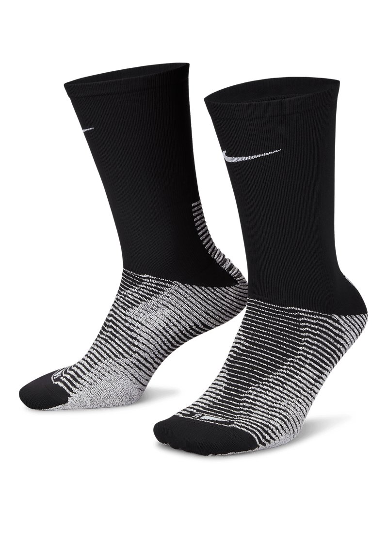 Svarte sportssokker med ribbet tekstur, med en hvit Nike-logo og et grått stripemønster rundt fotområdet.