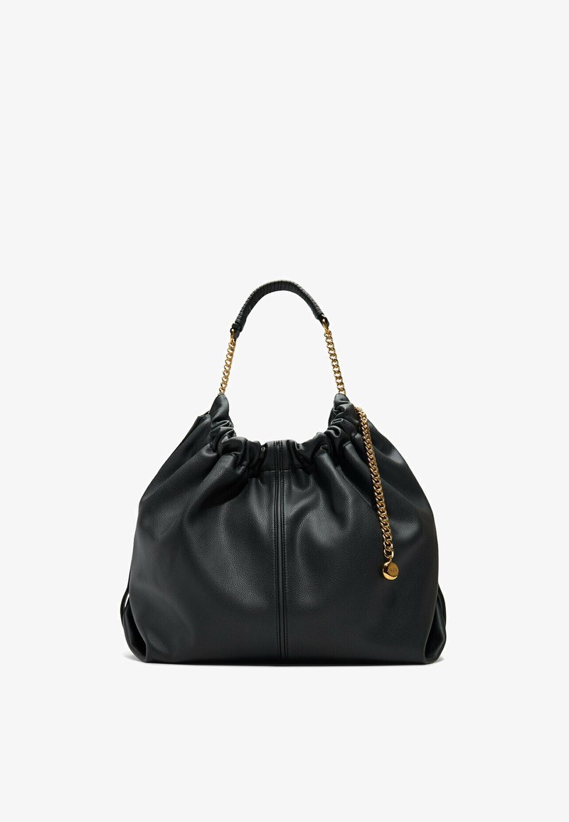 Black leather pouch bag with gathered top, gold chain handle, and textured surface. Features soft, slouchy design for a casual aesthetic.