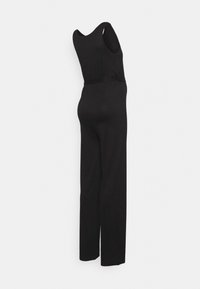 Macacão preto com corpete justo, design de perna larga e decote em forma de baía. Feito de um tecido liso e elástico, com um ajuste descontraído.