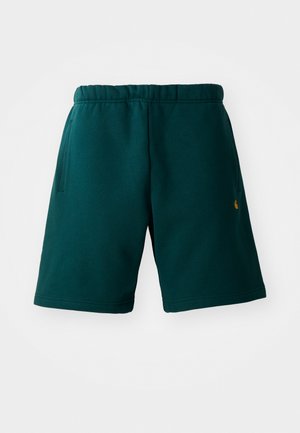 Donkergroene katoenen shorts met een elastische tailleband, zijzakken en een klein logo aan de onderzijde. Soepele textuur en knielang ontwerp.