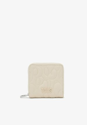 Pale beige leather wallet with embossed pattern, zip closure, and faint "TOUS" logo at the front, featuring rounded edges and subtle texture.