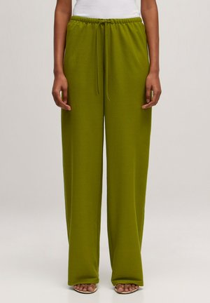 Green wide-leg pants made of soft fabric, featuring an elastic waistband with a drawstring, and a smooth texture.