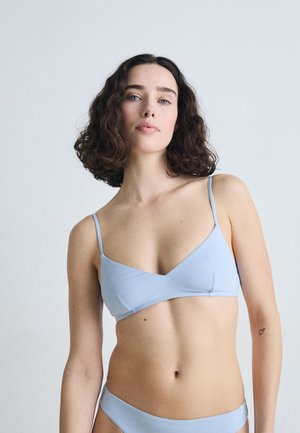 Light blue bikini set featuring a minimalist design. Top has a V-neck shape and thin straps, while briefs have a clean cut. Soft texture.