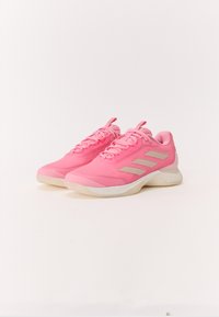 Pink athletic shoes with a smooth texture, featuring three beige stripes on the sides, shoe laces, and a cushioned sole for support.