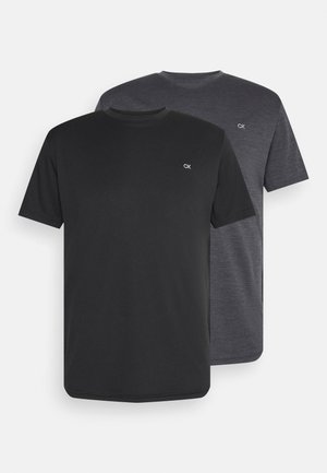 Two crew-neck t-shirts in black and dark grey, made of soft cotton, featuring a small white logo on the chest and short sleeves.