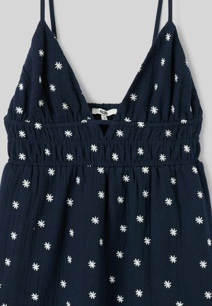 Robe sans manches bleu marine avec motifs d'étoiles blanches brodées, décolleté en V, et détail de taille smockée élastique.