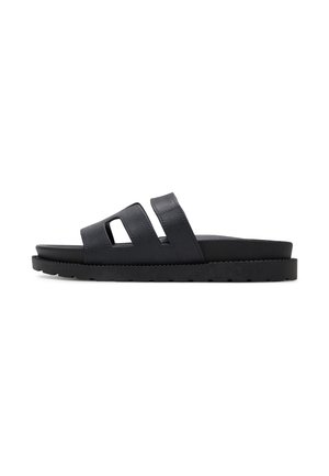 Schwarze Slidesandalen mit zwei Ausschnitt-Riemen, aus glattem Leder gefertigt. Verfügen über eine dicke Sohle mit texturiertem Profil für besseren Halt.