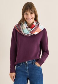 Knitted purple sweater layered with a multicolored checkered scarf featuring red and turquoise accents. Casual fit and soft texture.