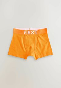 Boxer shorts orange avec un design ajusté, dotés d'une ceinture élastique de la même teinte, portant l'inscription "NEXT."