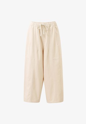 Beige brede broek met elastische tailleband en trekkoord, met verticale naden en een ontspannen pasvorm.