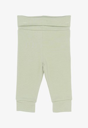 Világoszöld, puha tapintású pamutnadrág széles derékkal és szűkített szárakkal a bokánál. Egyszerű, díszítés nélküli dizájn.