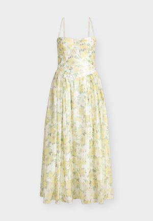 Αμάνικο φόρεμα μήκους μέχρι το πάτωμα με κίτρινο λουλουδένιο σχέδιο και εφαρμοστή μπούστα, με λεπτές τιράντες στους ώμους και φούστα με πλούσιες πιέτες.