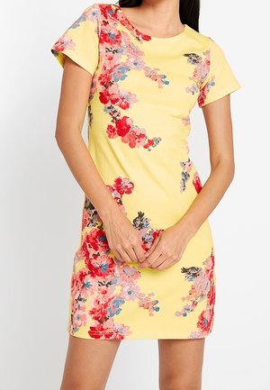 Yellow floral dress featuring short sleeves and a fitted design, detailed with pink, red, and blue flowers, creating a vibrant pattern.