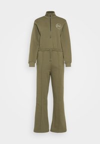 Combinaison en polaire vert olive avec un col montant, demi-zip, taille élastique et jambes évasées. Présente un logo imprimé sur la poitrine.