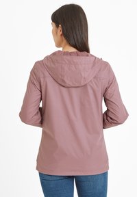Light pink waterproof jacket with a hood, featuring a smooth texture and elastic cuffs, shown from the back with minimal detailing.