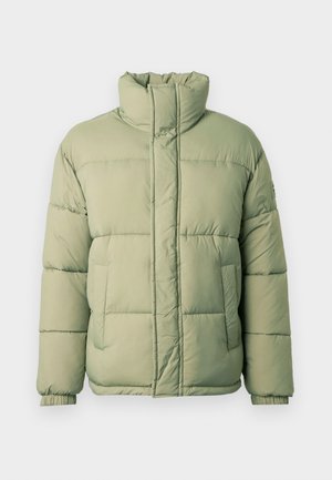 Gaisa džemperis gaiši zaļā krāsā ar augstu apkakli, horizontālām šuvēm, elastīgām piedurknēm un divām priekšējām kabatām. Mīksta, teksturēta auduma.