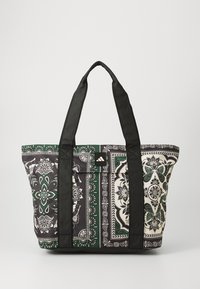 Tote bag with black straps, featuring a floral pattern in green, white, and black, made of durable fabric, with a structured rectangular shape.