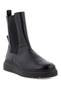 Bottine en cuir noir avec des panneaux élastiques sur les côtés, bout rond et semelle en caoutchouc épais avec un motif de semelle pour une meilleure adhérence.