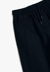 Schwarze Jogginghosen aus Baumwolle, mit elastischem Bund, Kordelzug und Seitentaschen. Glatte Textur mit einem lässigen Design.