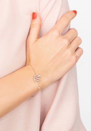 Rose gold bracelet featuring a stylized charm with three horizontal lines adorned with small clear stones, connected to a delicate chain.