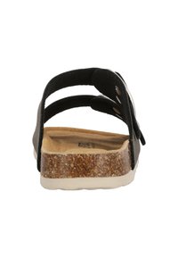 Svart sandal med justerbara remmar, fotbädd liknande kork och vit sula. Har metalliska detaljaccents och en strukturerad ovandel.