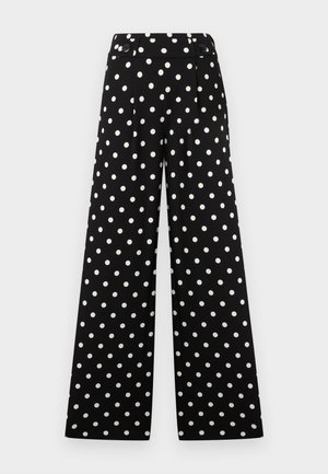 Pantalon large noir à pois blancs, taille haute, avec ceinture boutonnée.